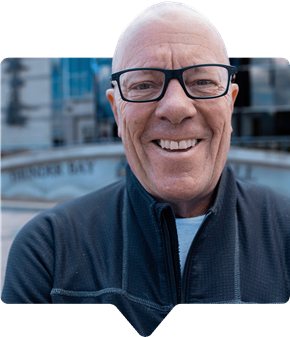 photo of smiling man wearing glasses
